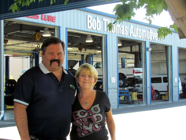 Car Shop Medford owners standing outside their automotive service facility.